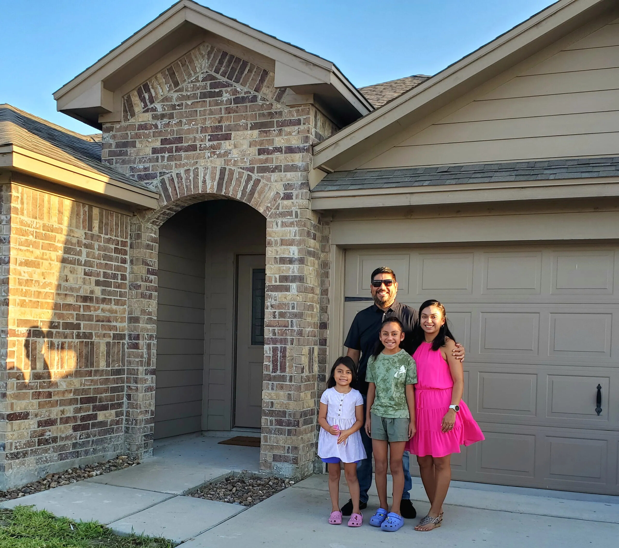 happy-family-in-front-of-new-home-corpus christi-tx